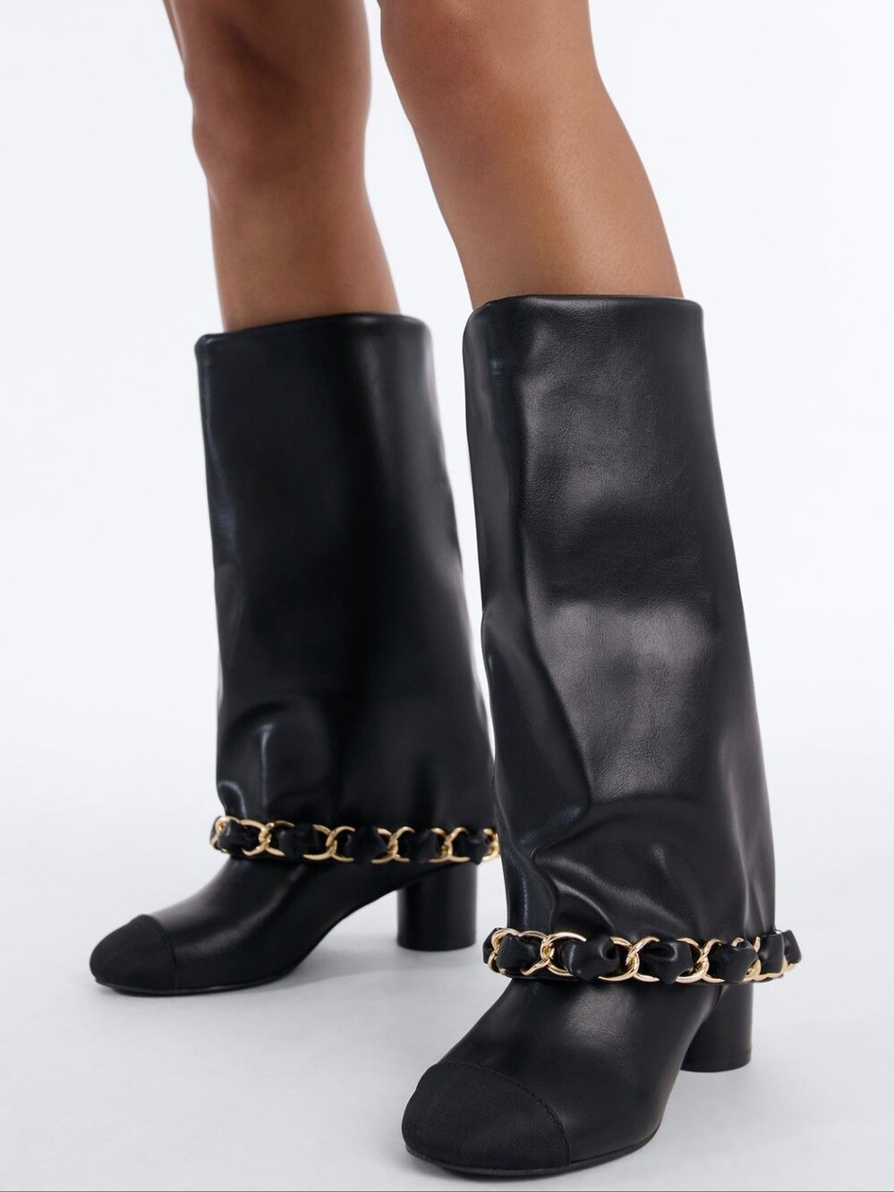 Women's leather thigh-high boots with a decorative chain are the epitome of prem